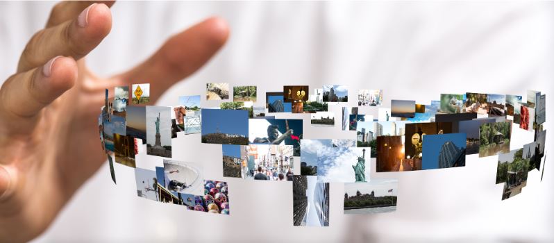 Hand mit vielen herumfliegenden Fotos